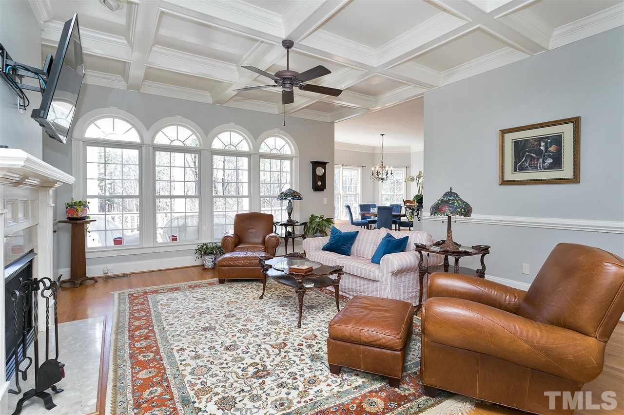 2521 Hunters Meadow Lane Raleigh, NC 27606 - Photo 7 of 30 a living room with furniture a chandelier and a large window