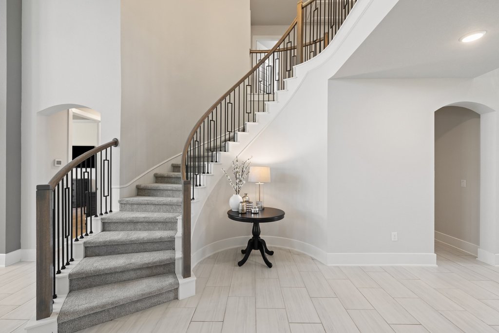 741 Rawson Bend Austin, TX 78738 - Photo 23 of 40 A grand staircase winds up to the second floor bedrooms and living areas.