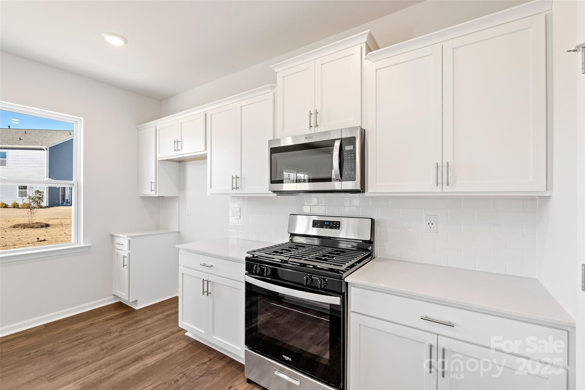 365 Wheatfield Road Fletcher, NC 28732 - Photo 4 of 21 a kitchen with stainless steel appliances white cabinets and a stove