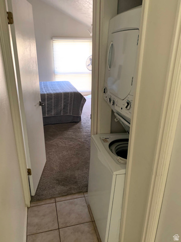 860 South Village Road, Unit B11 St. George, UT 84770 - Photo 13 of 19 Laundry area featuring light colored carpet, stacked washer / drying machine, and light tile patterned floors