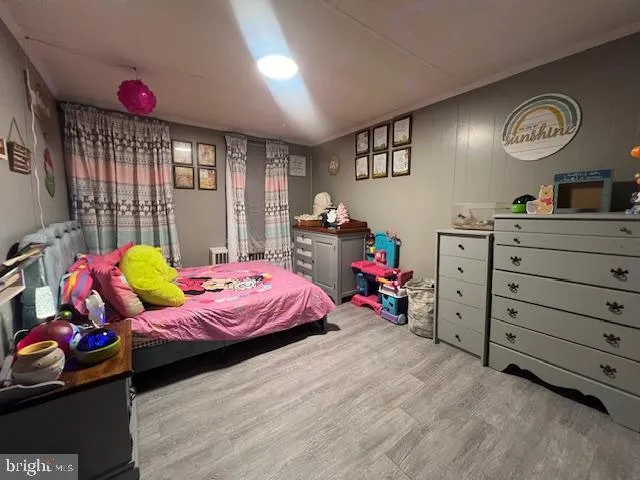 a bedroom with a bed closet and window