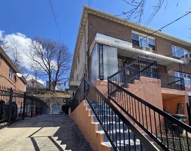 a view of a house with wooden fence