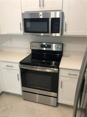 a stove top oven sitting inside of a kitchen