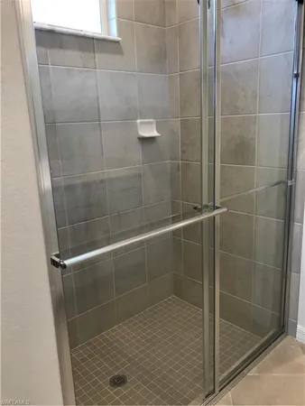 a bathroom with a glass shower door