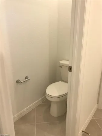 a white toilet sitting next to a shower