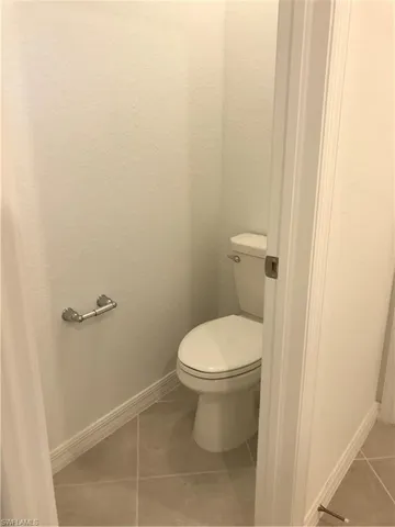 a white toilet sitting next to a shower