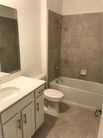a bathroom with a sink a toilet and bathtub