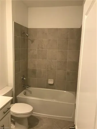 a bathroom with a bathtub and a toilet