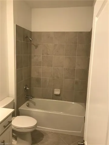 a bathroom with a bathtub and a toilet