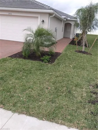 a view of an empty room with closet and a window