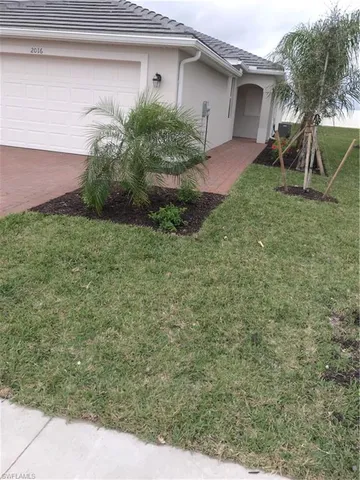 a view of an empty room with closet and a window