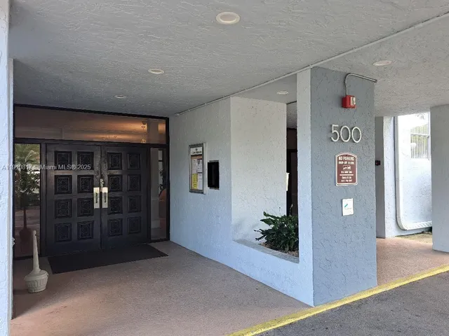 a living room with couches chairs and a chandelier