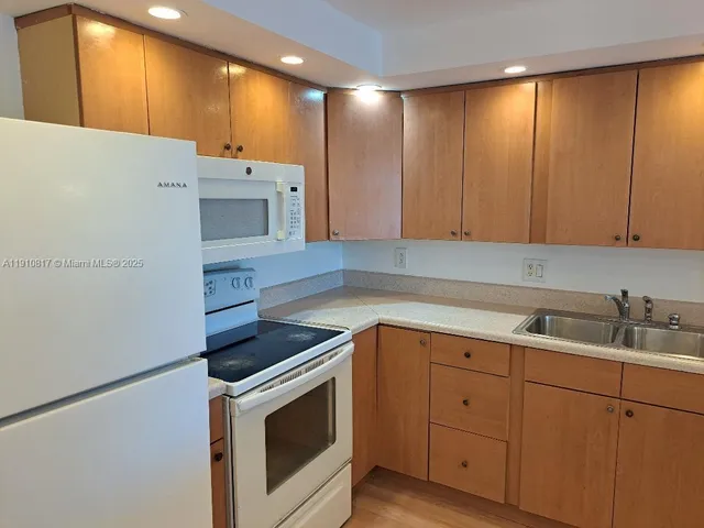 a large kitchen with a wooden cabinets and a stainless steel appliances