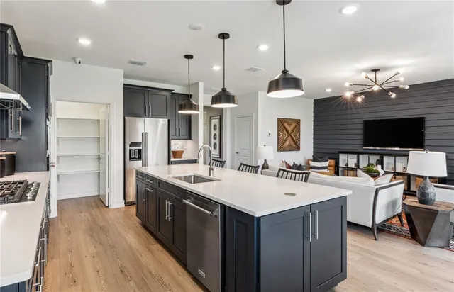 a large kitchen with kitchen island a sink counter space and stainless steel appliances