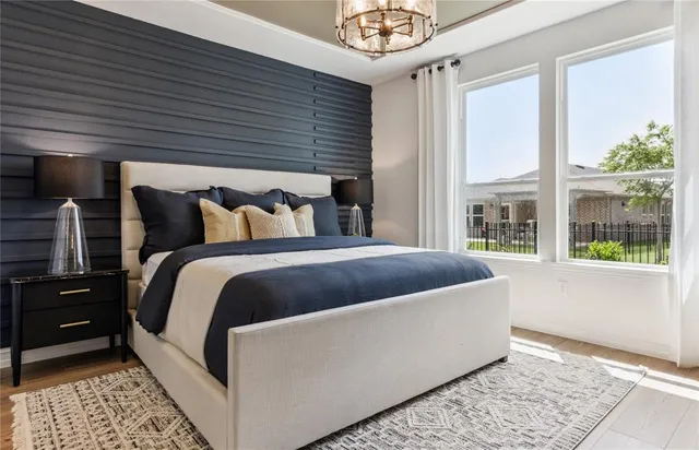 a bed sitting in a bedroom next to a window