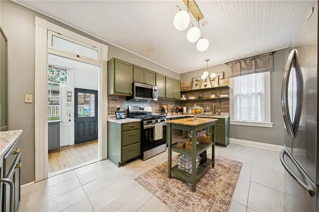 a kitchen with sink cabinets and refrigerator