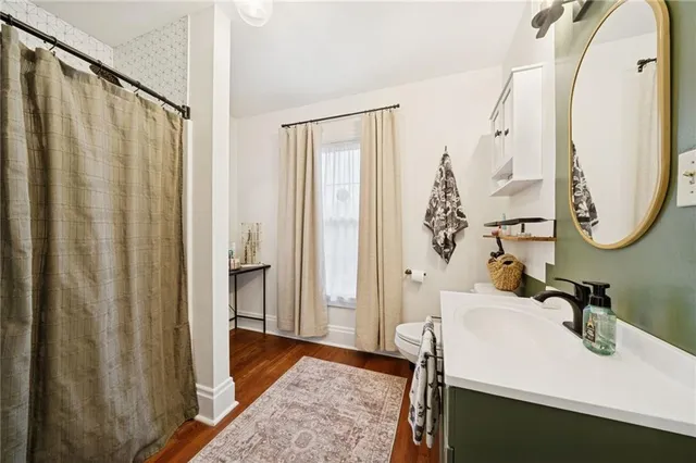 a bathroom with a toilet sink and mirror