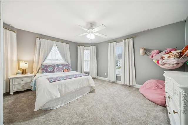 a bedroom with bed and window