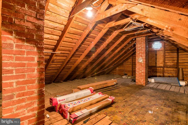 a backyard of a house with wooden fence and large windows