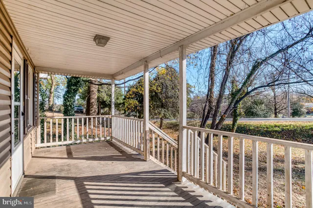 a view of a porch with wooden floor and fence