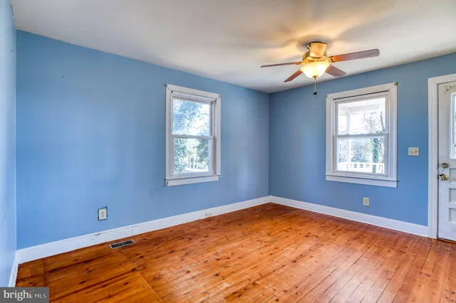 wooden floor and window in an empty room