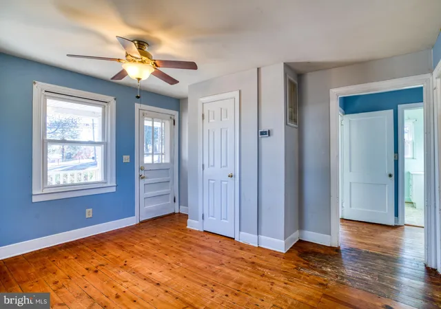 a view of empty room with wooden floor