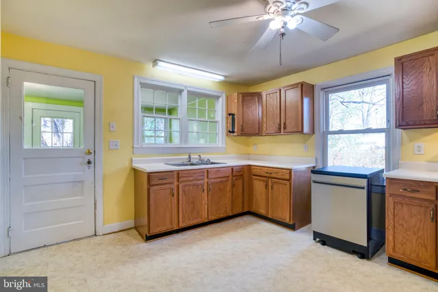 a kitchen with stainless steel appliances granite countertop a dishwasher a stove and a sink with dishwasher