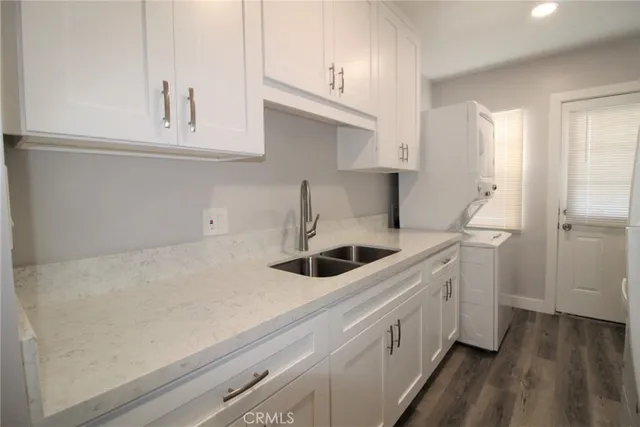 a kitchen with stainless steel appliances a sink stove and cabinets