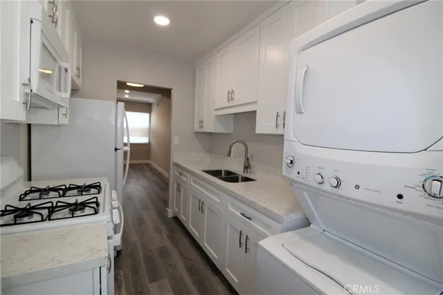 a kitchen with stainless steel appliances a sink stove and cabinets