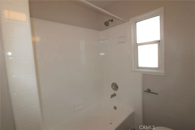 a bathroom with a bathtub and shower