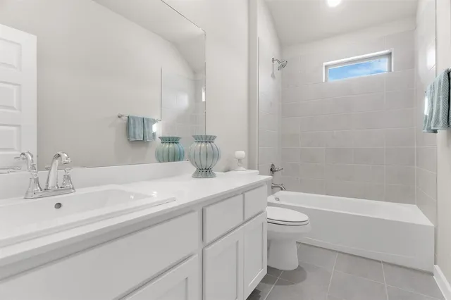 a bedroom with a bed a couch and dresser