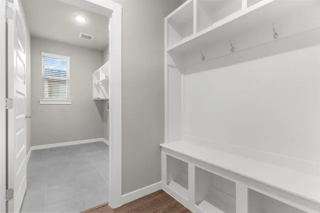 a backyard of a house with lots of green space and wooden fence