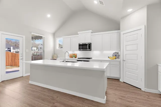 a kitchen with stainless steel appliances a white stove top oven and a refrigerator