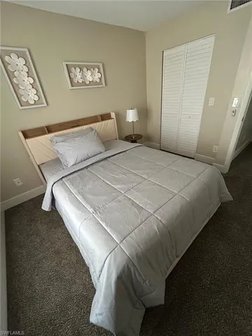 a bedroom with a bed and a table in it