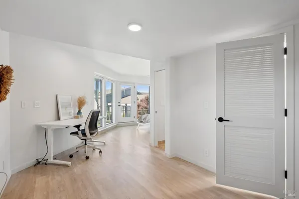 a living room with furniture and a floor to ceiling window