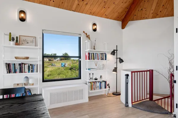 a living room with furniture a potted plant and a fireplace