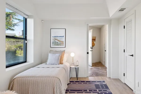 a bedroom with a large bed and a large window