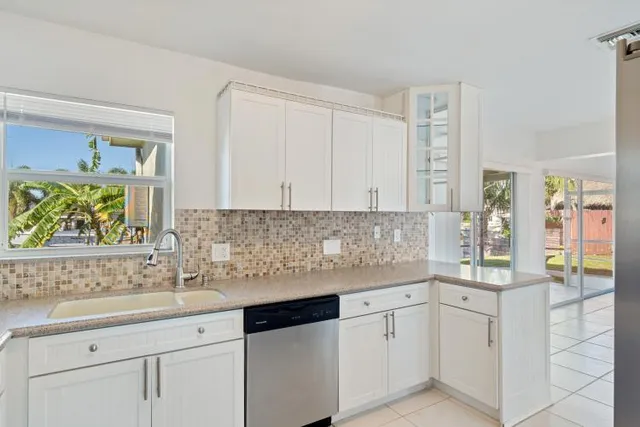 a view of a kitchen with dining table and chairs