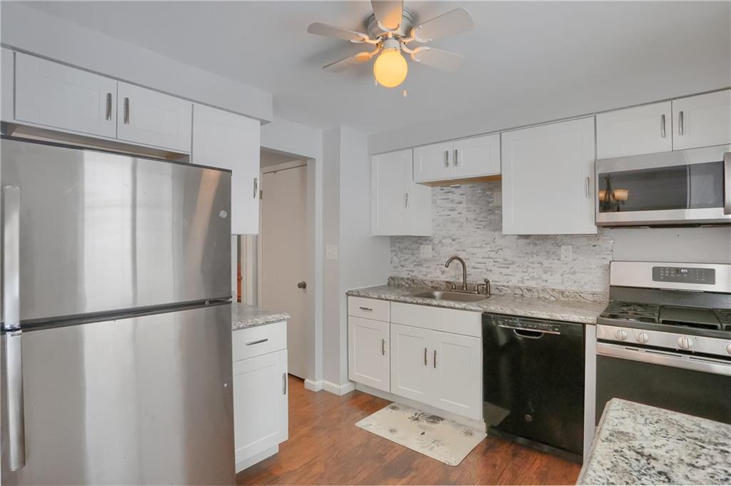 236 Timber Drive Trafford, PA 15085 - Photo 6 of 16 a kitchen with stainless steel appliances granite countertop a refrigerator sink and stove