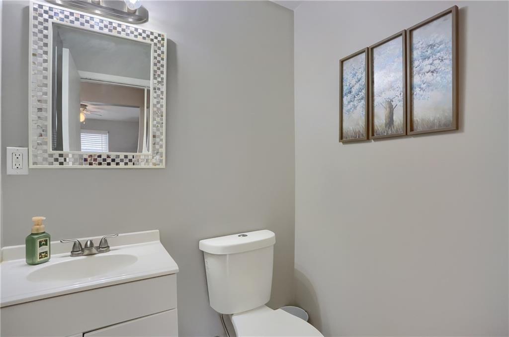 236 Timber Drive Trafford, PA 15085 - Photo 7 of 16 a bathroom with a toilet sink vanity and mirror