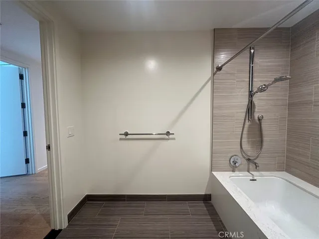 a bathroom with a tub sink and mirror