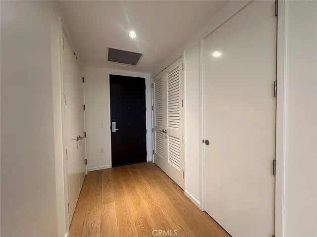 a view of hallway with wooden floor