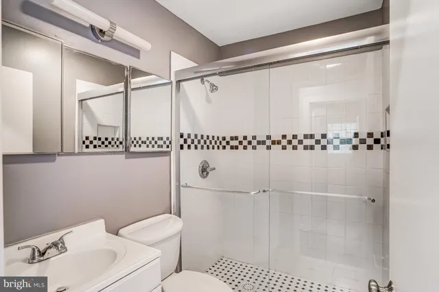 a bathroom with a toilet a sink and a shower