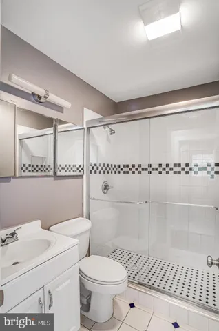 a bathroom with a toilet a sink and a shower