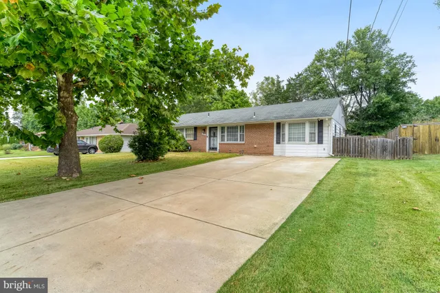 a view of house with backyard and a garden