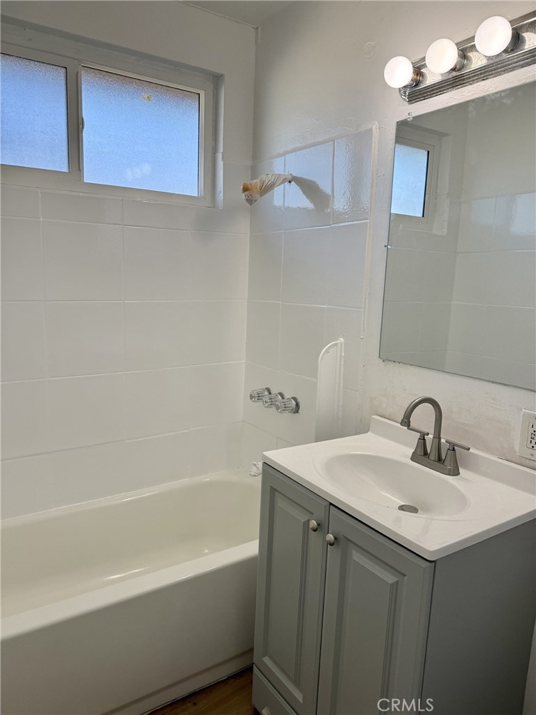 4830 Canoga Street, Unit J Montclair, CA 91763 - Photo 11 of 12 a bathroom with a sink a toilet and shower