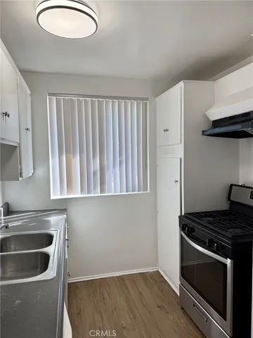 a kitchen with granite countertop a stove and a sink
