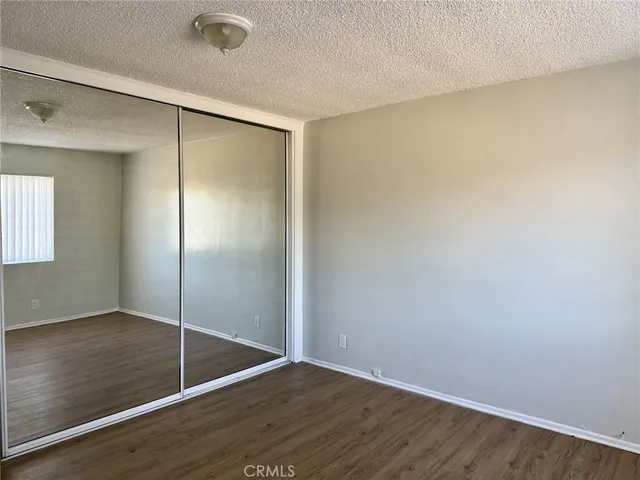 an empty room with wooden floor