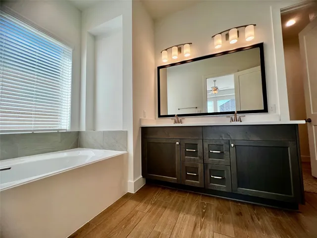 a bathroom with a sink vanity and a mirror