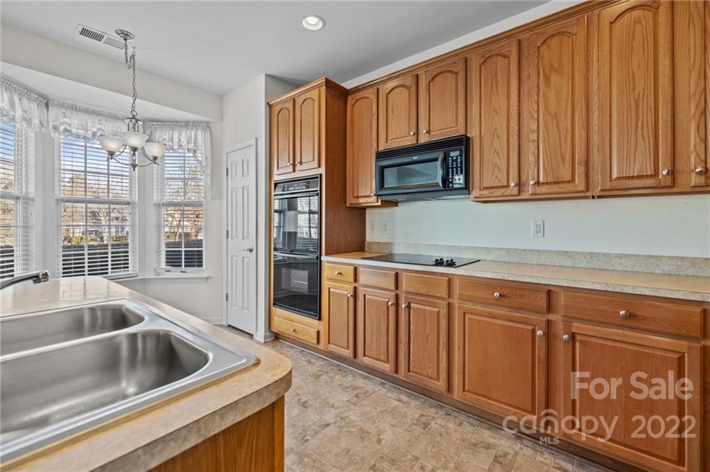 220 Garnet Court Fort Mill, SC 29708 - Photo 32 of 36 a kitchen with granite countertop a sink and cabinets